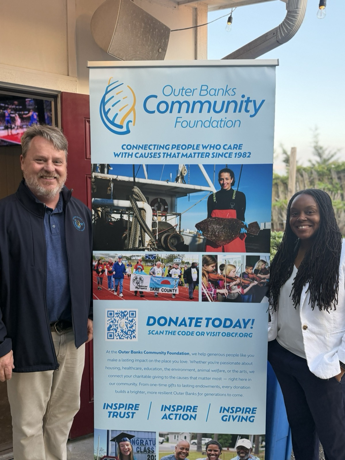 Latoya Robinson with a community foundation's executive at a funder mixer, April 2026